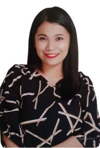 Smiling woman with long black hair.
