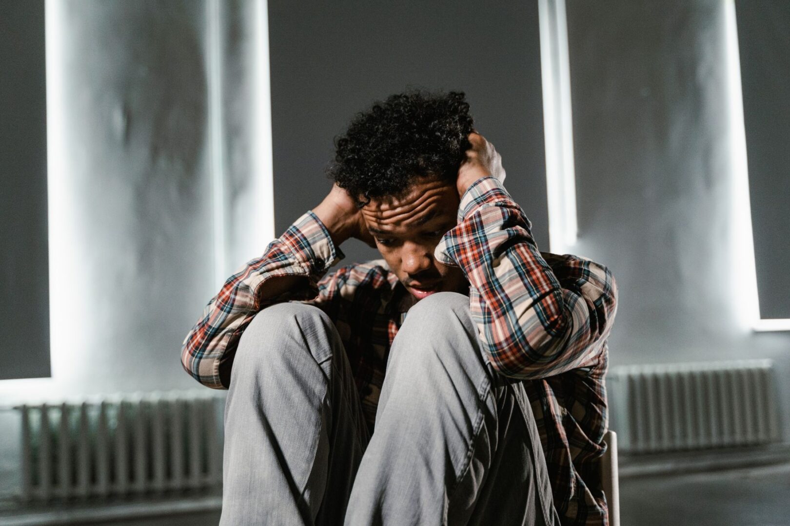 Young man holding his head with depression